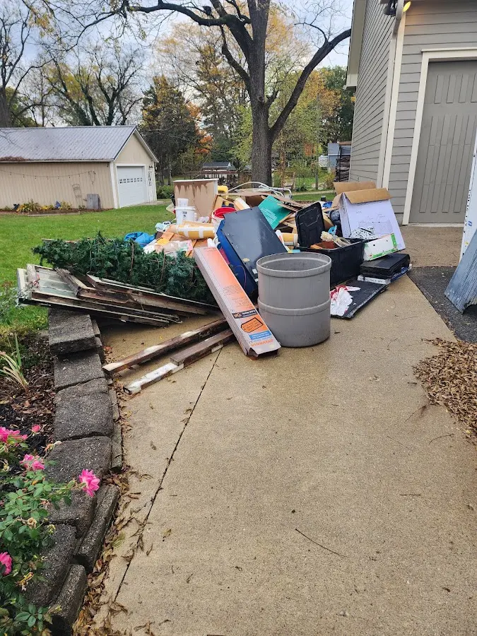 Dumpster being loaded with debris for Estate Cleanout Dumpster Rental in Liberty